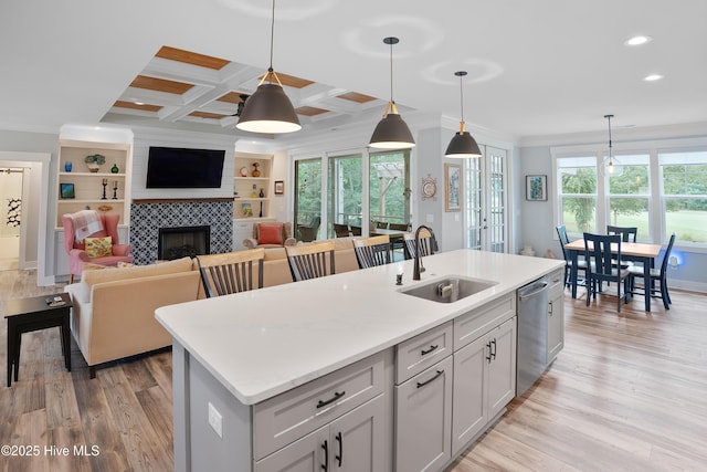 1611 Golfers Ridge Dr SE, Bolivia, NC 28422 - kitchen with dishwasher, crown molding, a tiled fireplace, light wood-type flooring, and pendant lighting