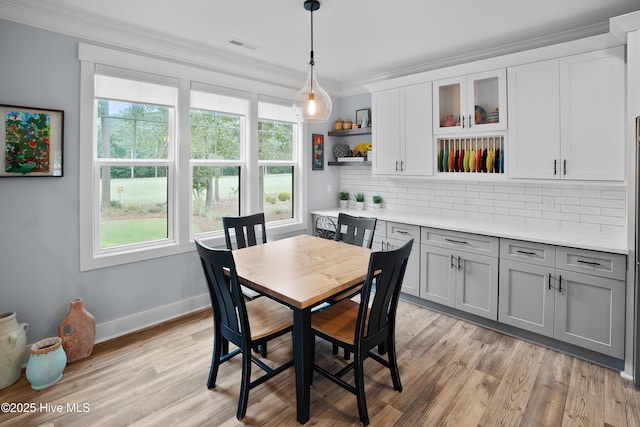 1611 Golfers Ridge Dr SE, Bolivia, NC 28422 - dining area featuring plenty of natural light, crown molding, and light wood-type flooring