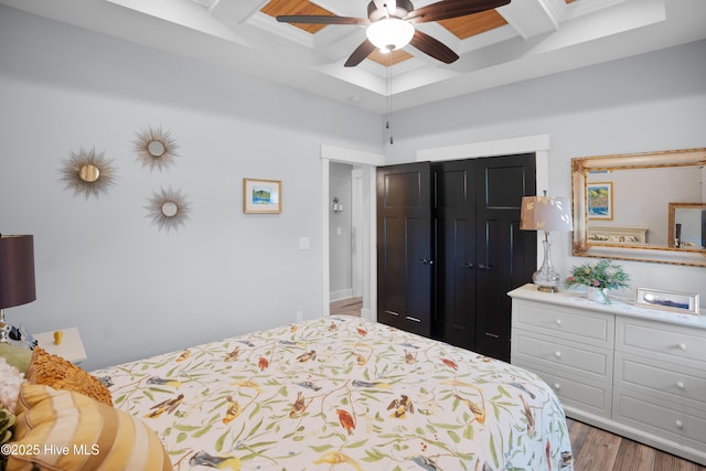 1611 Golfers Ridge Dr SE, Bolivia, NC 28422 - bedroom featuring coffered ceiling, beamed ceiling, wood finished floors, a closet, and a ceiling fan
