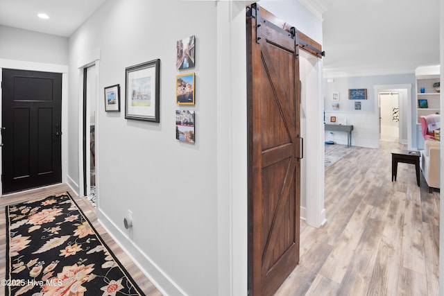 1611 Golfers Ridge Dr SE, Bolivia, NC 28422 - hall featuring a barn door, light wood-type flooring, recessed lighting, and crown molding