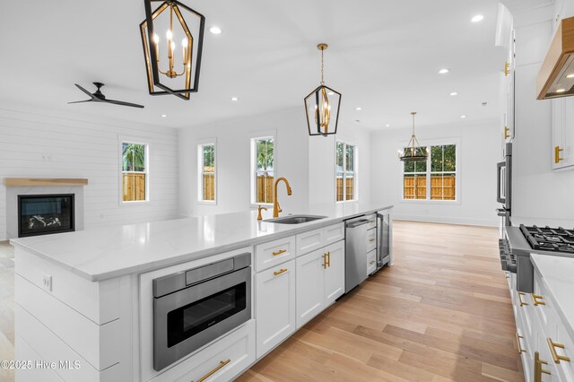 kitchen with stainless steel gas stovetop, premium range hood, tasteful backsplash, and white cabinets