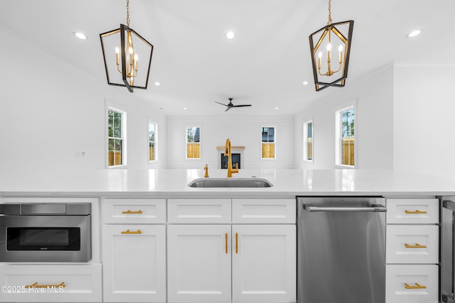 kitchen with white cabinetry, dishwasher, sink, and pendant lighting