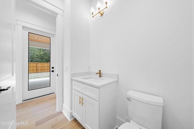 bathroom featuring vanity, toilet, and hardwood / wood-style floors