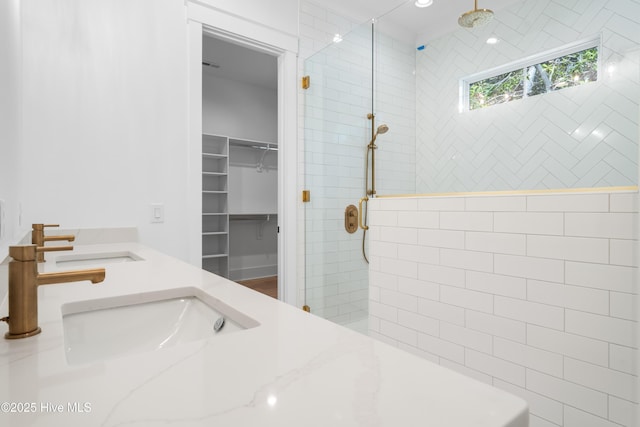 bathroom with vanity and tiled shower