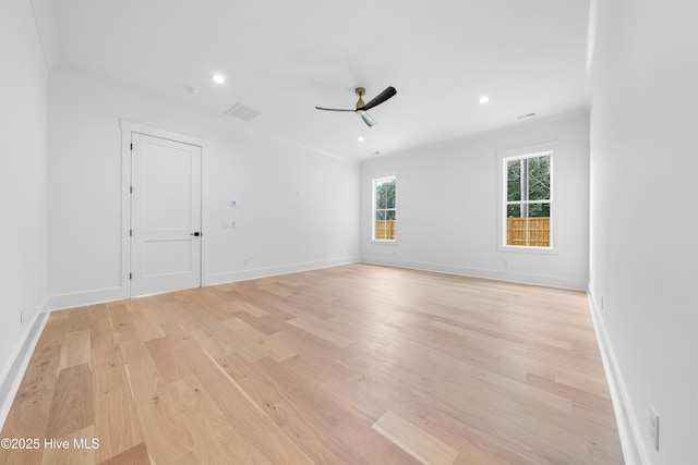 spare room with ceiling fan and light wood-type flooring