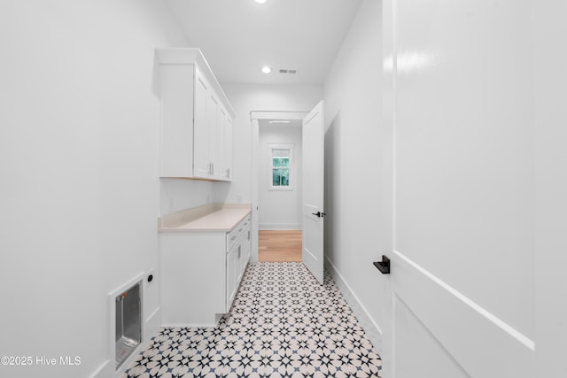 clothes washing area with cabinets and electric dryer hookup