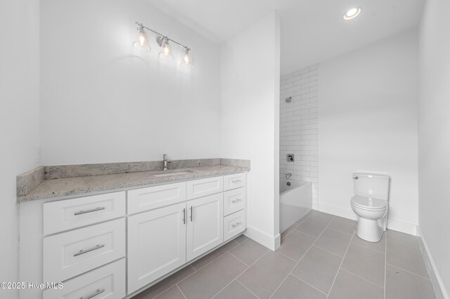 bathroom with vanity, tile patterned floors, and tiled shower / bath