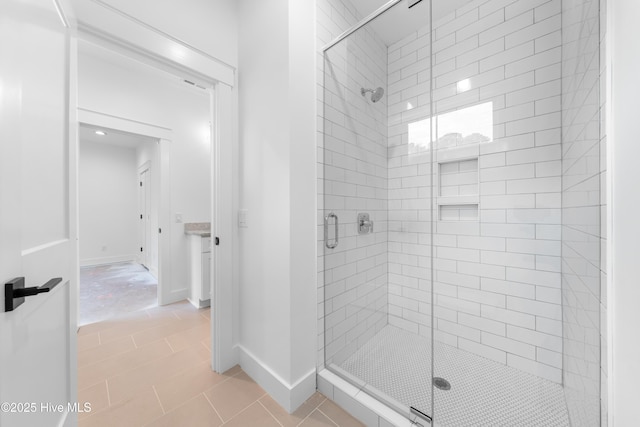 bathroom with tile patterned floors and walk in shower