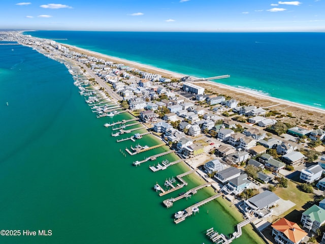 aerial view with a water view and a view of the beach