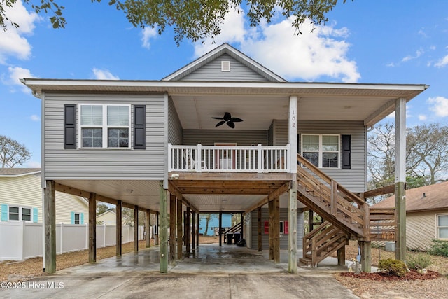 coastal inspired home featuring a carport, covered porch, and ceiling fan