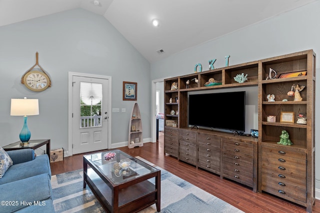 living room featuring high vaulted ceiling and dark hardwood / wood-style flooring