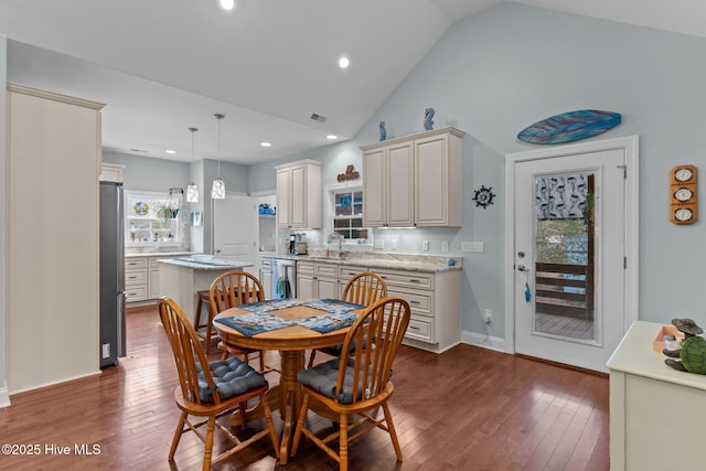 dining room with high vaulted ceiling, dark hardwood / wood-style floors, and sink