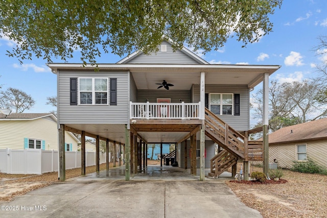 beach home featuring a carport, ceiling fan, and covered porch