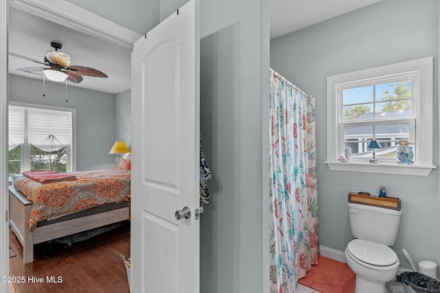 bathroom featuring hardwood / wood-style floors, toilet, and ceiling fan