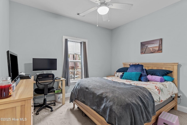 bedroom with light colored carpet and ceiling fan