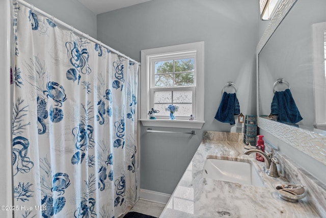 bathroom featuring vanity and a shower with shower curtain