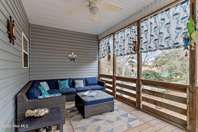 sunroom / solarium featuring ceiling fan