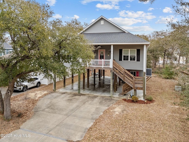 coastal home featuring a porch and a carport