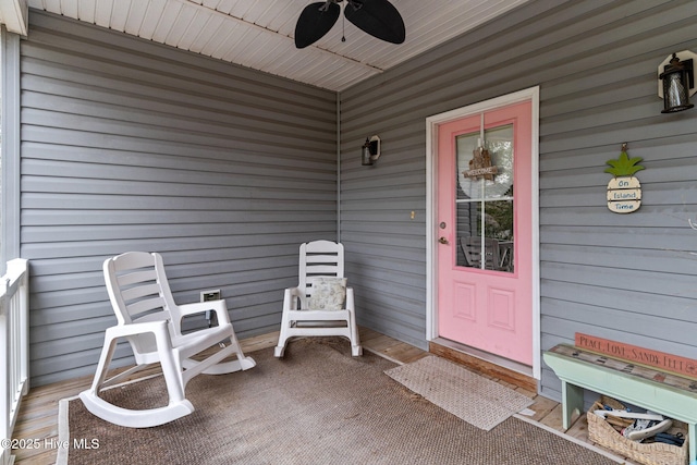 doorway to property with a porch and ceiling fan