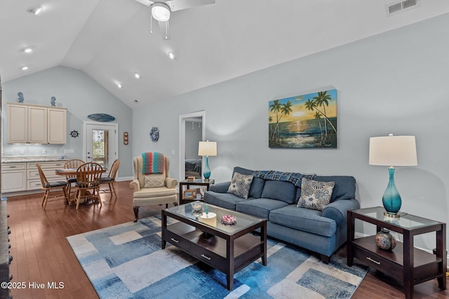 living room featuring wood-type flooring, vaulted ceiling, and ceiling fan