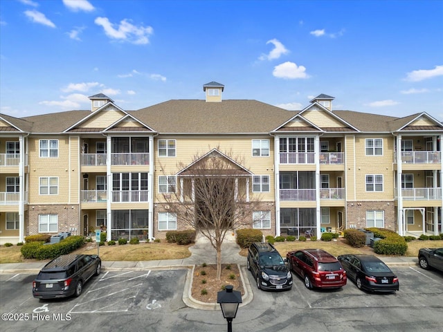 view of property featuring uncovered parking