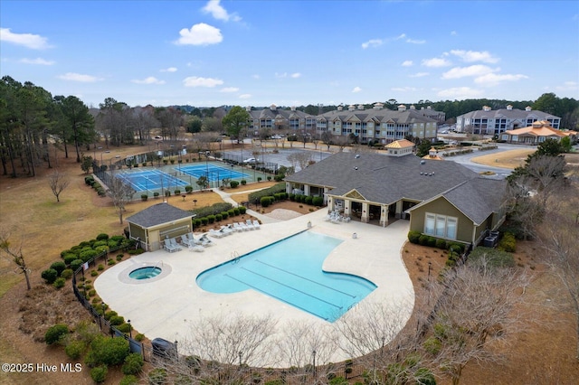 pool featuring a residential view, a patio, central AC unit, and fence