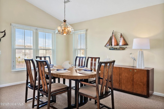 carpeted dining room featuring lofted ceiling and a notable chandelier