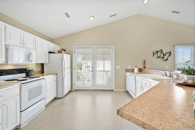 kitchen with white cabinetry, vaulted ceiling, sink, and white appliances