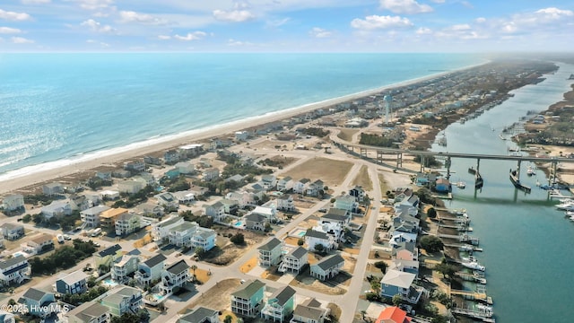 aerial view with a water view and a beach view