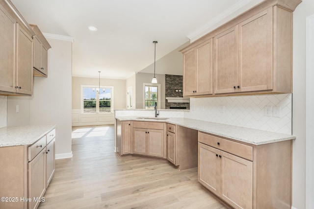 68 Tee Dr, Selma, NC 27576 - kitchen featuring a peninsula, light brown cabinetry, a sink, and light wood-style flooring