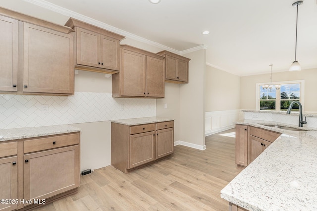 68 Tee Dr, Selma, NC 27576 - kitchen with light wood-style floors, light stone countertops, a notable chandelier, and a sink