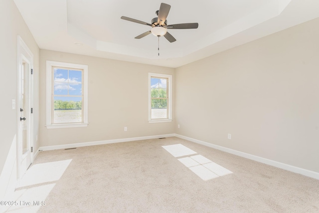 68 Tee Dr, Selma, NC 27576 - unfurnished room featuring a raised ceiling, a ceiling fan, baseboards, and light carpet