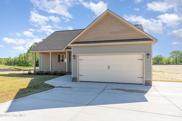 68 Tee Dr, Selma, NC 27576 - view of front facade featuring a garage, a shingled roof, a front yard, and concrete driveway