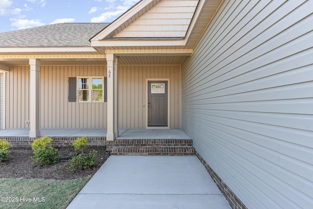68 Tee Dr, Selma, NC 27576 - doorway to property with board and batten siding, a shingled roof, and covered porch