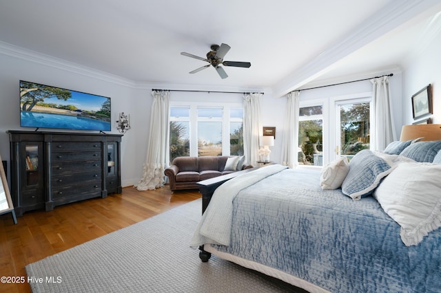 bedroom featuring ceiling fan, access to exterior, crown molding, and wood finished floors