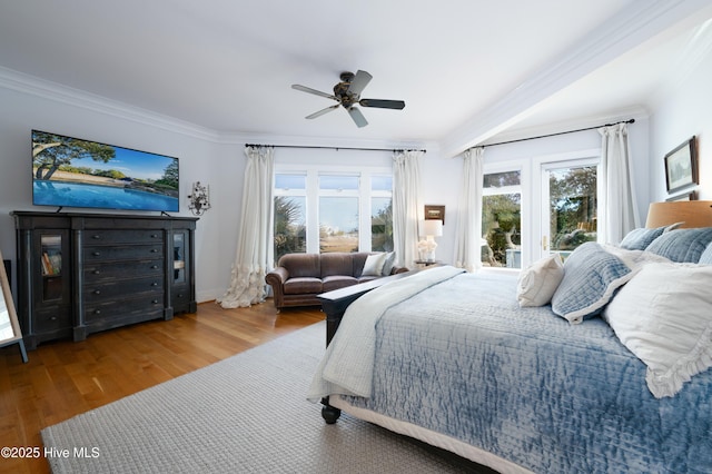 bedroom featuring ornamental molding, ceiling fan, and wood finished floors
