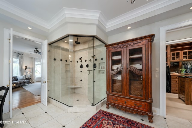 bathroom featuring a ceiling fan, crown molding, a shower stall, recessed lighting, and tile patterned floors