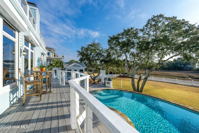 view of swimming pool featuring a yard, a fenced in pool, and fence