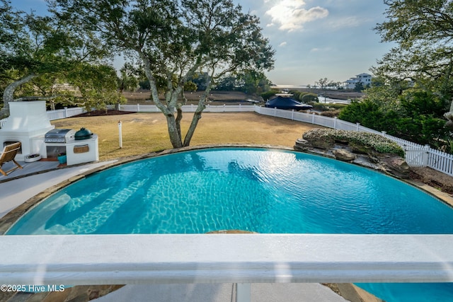 view of pool featuring area for grilling, a fenced backyard, a fenced in pool, and a lawn