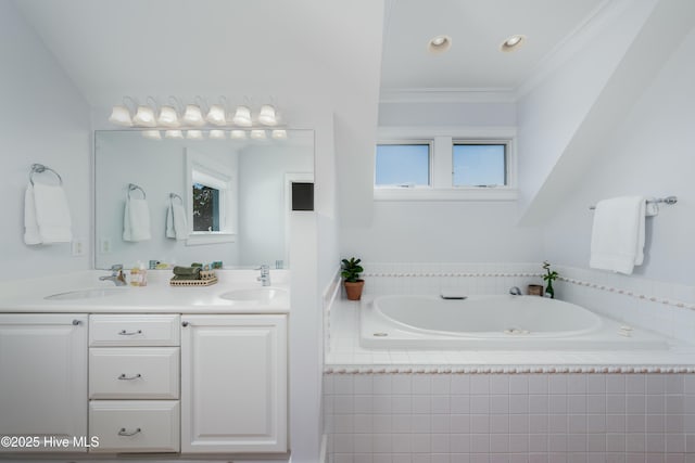 bathroom featuring ornamental molding, a garden tub, a sink, and double vanity