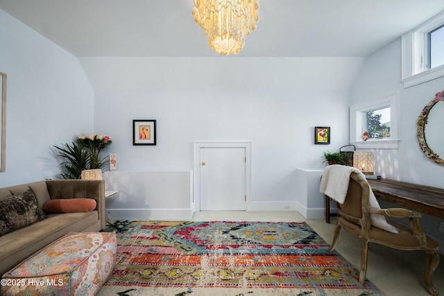 carpeted home office featuring lofted ceiling, an inviting chandelier, and baseboards