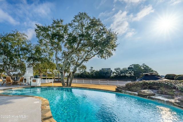 view of pool featuring a patio area, fence, and a fenced in pool