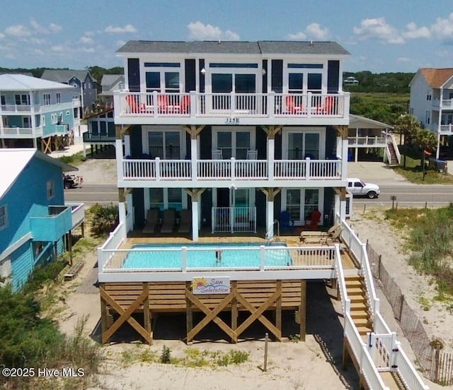 back of house with a fenced in pool