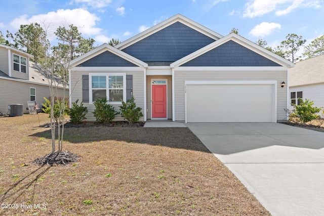 view of front of home with a front lawn, a garage, and cooling unit