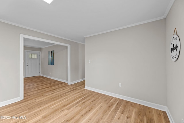 empty room with ornamental molding and light wood-type flooring