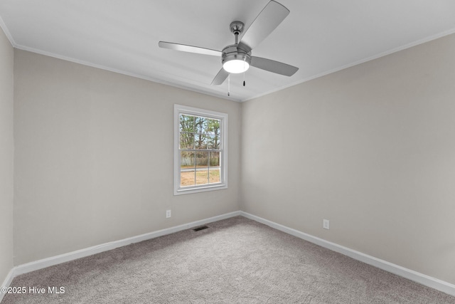 empty room featuring crown molding, ceiling fan, and carpet flooring