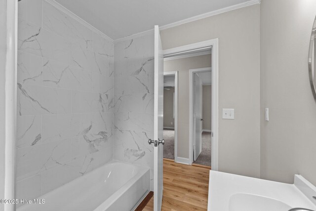 bathroom with hardwood / wood-style flooring, crown molding, and vanity