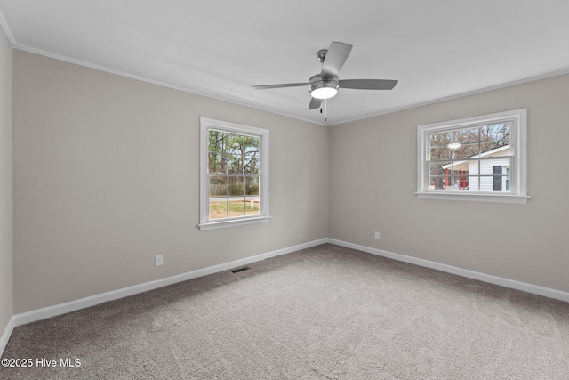 carpeted spare room featuring ornamental molding and ceiling fan