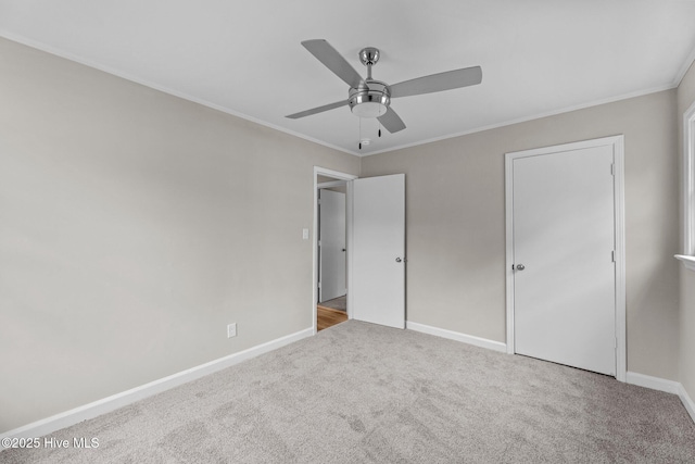 unfurnished bedroom with crown molding, ceiling fan, and light carpet