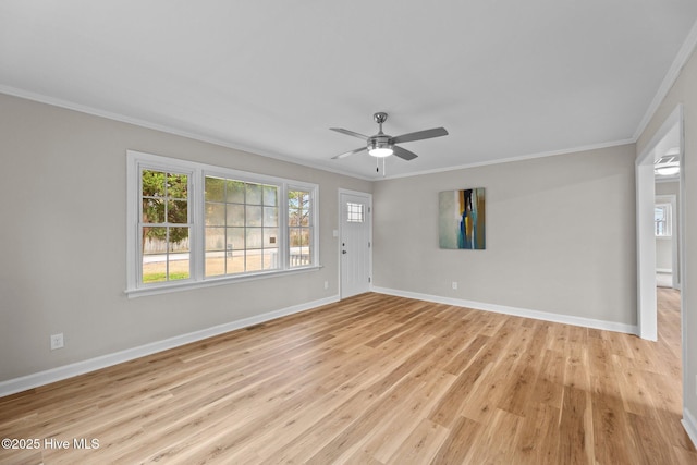 unfurnished living room featuring crown molding, plenty of natural light, and light wood-type flooring